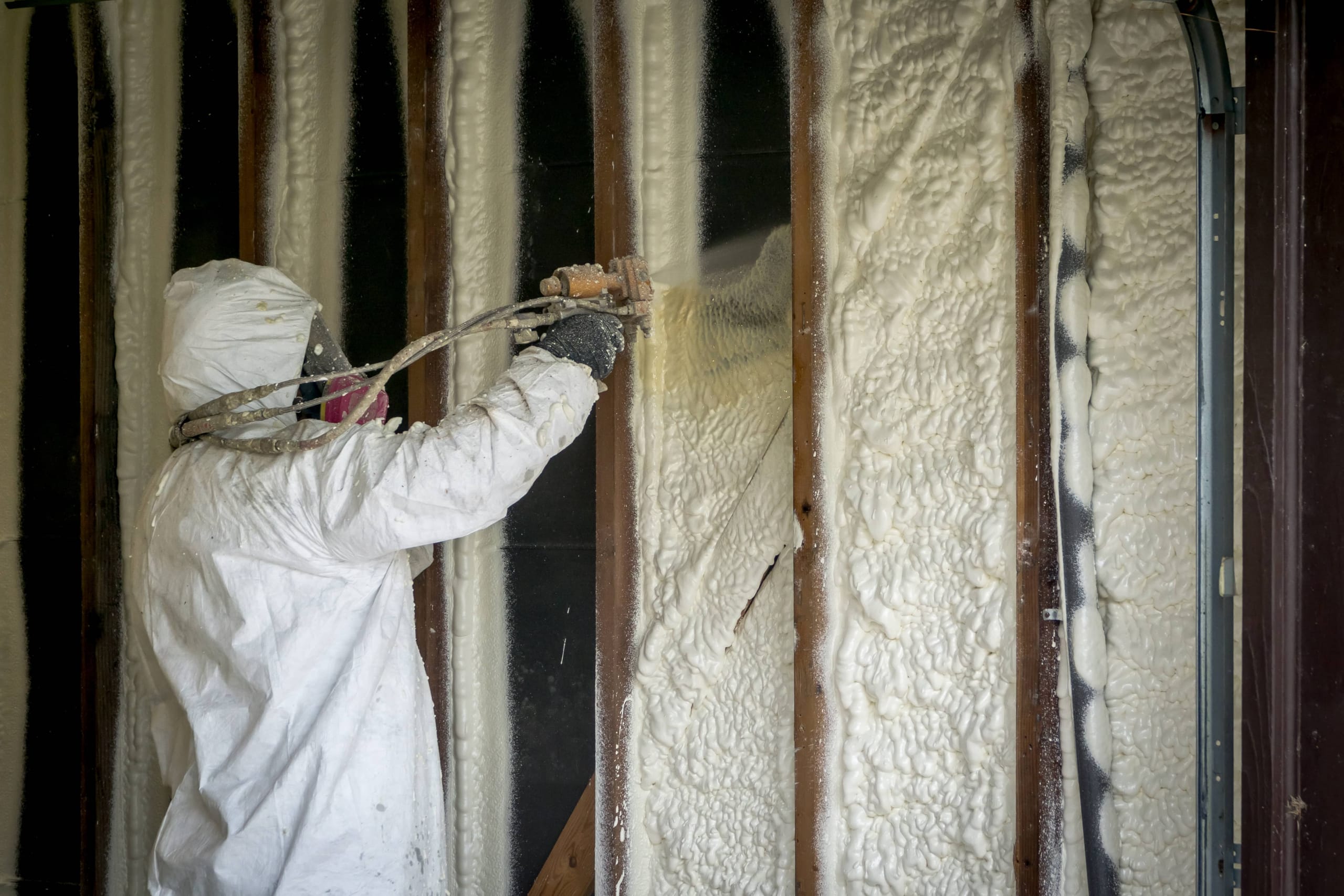 Spray foam insulation being applied in an attic